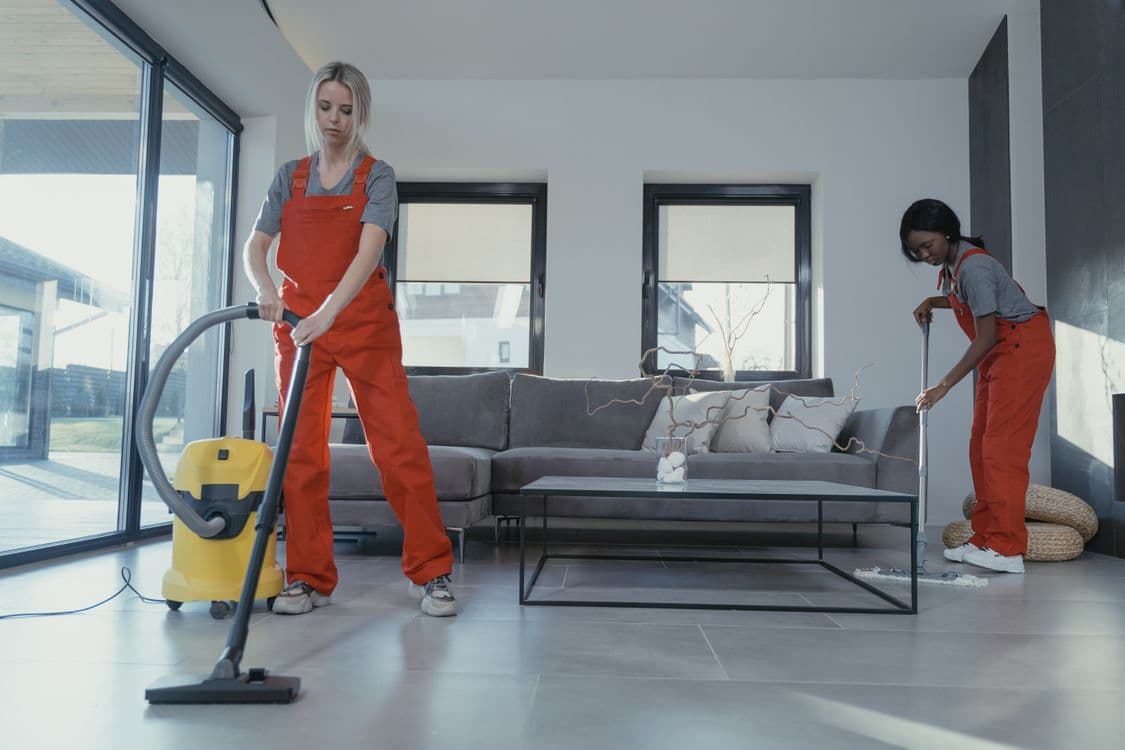 Professional cleaners in orange uniform ready to clean a home in Paphos, Cyprus