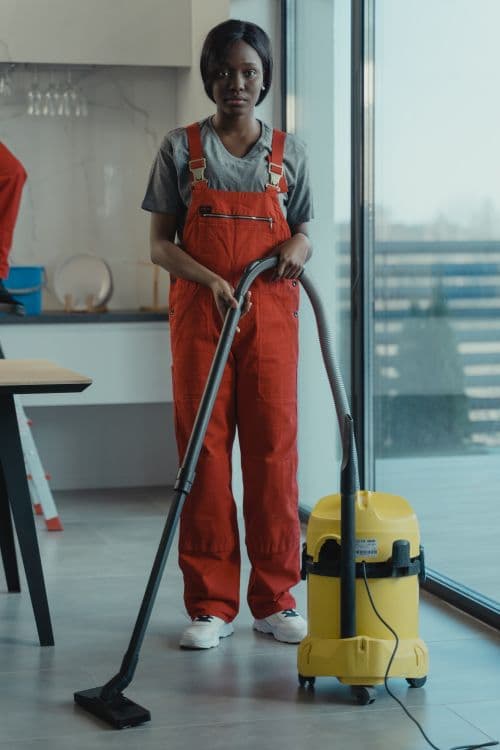 Professional cleaner using a vacuum on carpet in a Paphos home